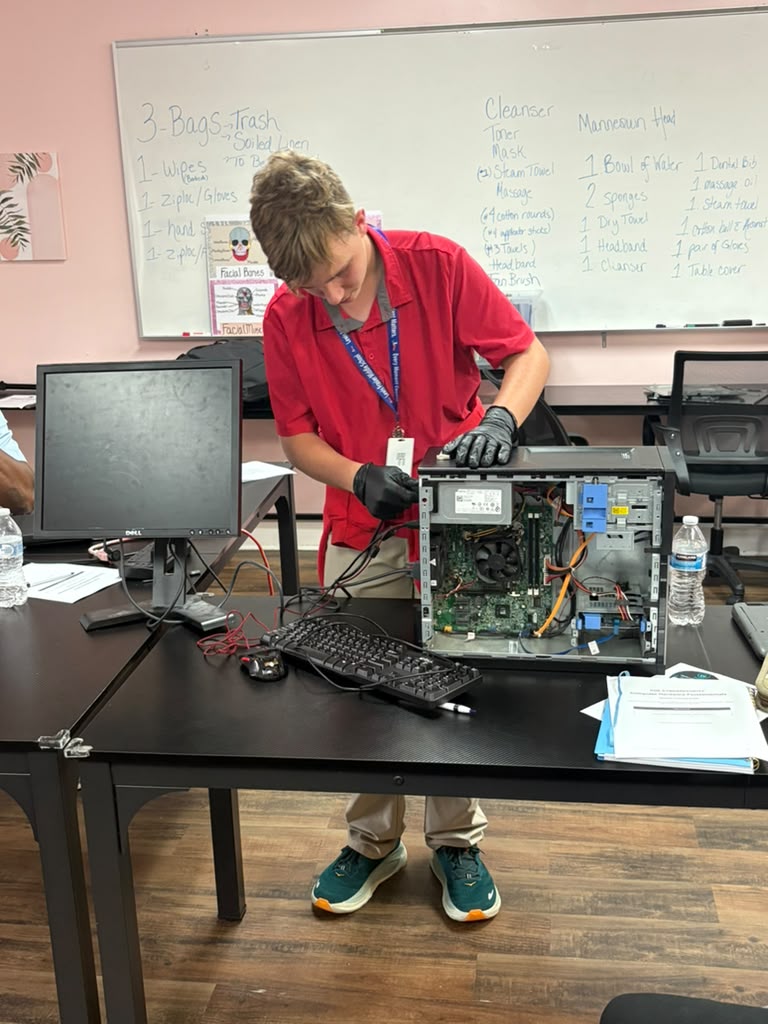 Young participant carefully installing memory modules into a desktop motherboard socket